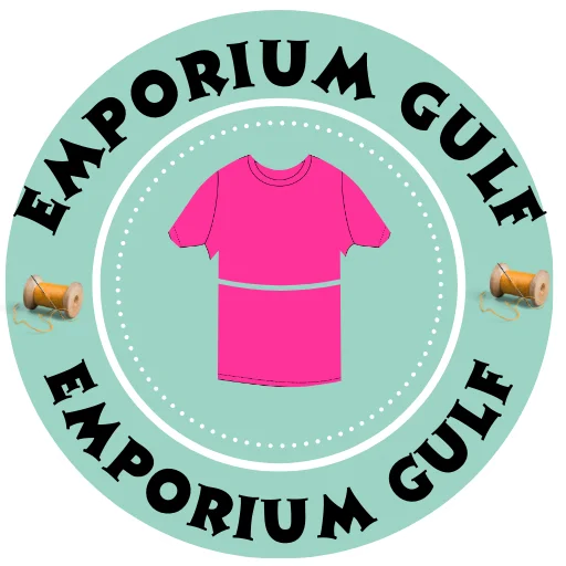 Emporium Gulf circular site icon and logo featuring a bright pink t-shirt illustration, sewing spools, and curved brand lettering on a teal background.