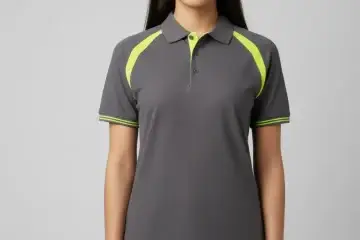 Women's dark grey dry-fit corporate polo shirt with fluorescent yellow shoulder panels and cuff tipping