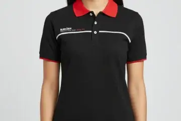Women's black corporate polo shirt with red collar, cuffs, and white chest piping